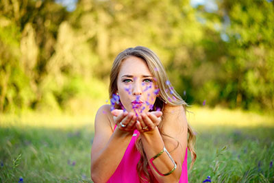 A woman blowing kisses