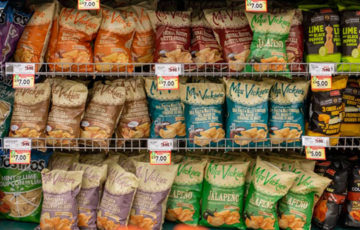 A shelf full of potato chip bags