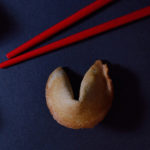 A fortune cookie and chopsticks
