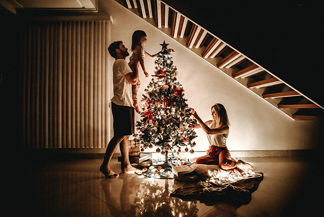 a girl putting a star on the tree