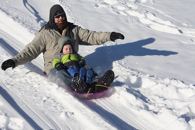sledding dad and a boy