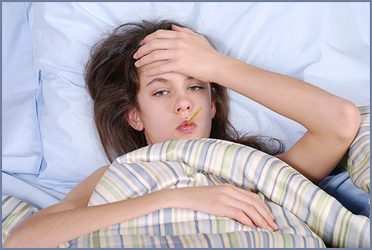 A girl being sick in bed