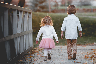 A little boy and a girl walking together