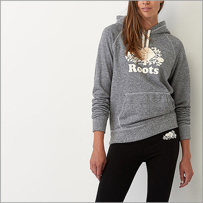 a woman wearing a roots sweater